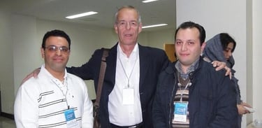 three men standing next to each other in a room