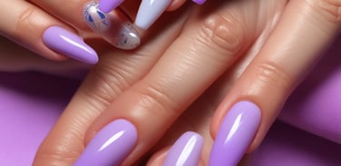 Close-up of a client's hands with freshly polished nails in soft pastel colors.