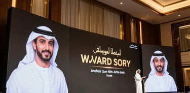 A corporate stage setup for an award ceremony in a prestigious Middle Eastern / Gulf venue, professional and sleek, dark wood accents with gold lighting, luxurious presentation screens, ready for an executive event.
