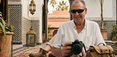 Professional commercial photographer holding a high-end digital camera during an on-location editori