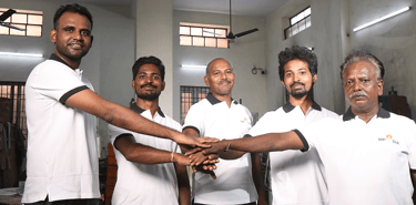 MP Asia Engineering team with joint hands in factory