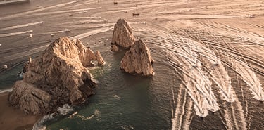 a boat traveling through the ocean with a boat in the water