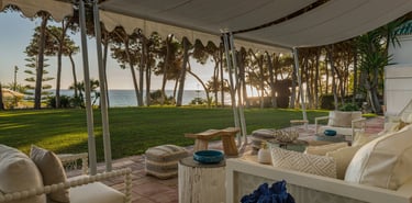 Covered beachfront terrace lounge with sunset sea views