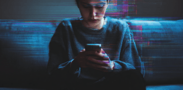 a man in a sweater sitting on a couch