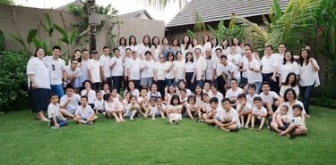 Large extended family group portrait at Lumbini Villas Jimbaran Bali captured in a spacious outdoor setting