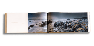 Panoramic coastal landscape spread from the Moments of Grace coffee table book by Koos van der Lende.