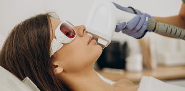 a woman in eye protection getting laser hair removal treatment