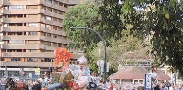 Battle of Flowers, float adorned with flowers, and women in fallera dresses