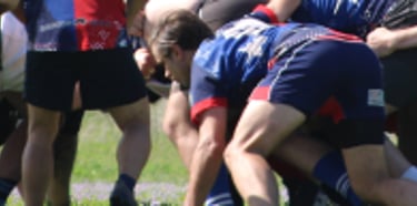 a group of people playing a game of rugby scrum maul 