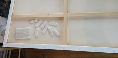 The back of a stretch canvas showing how Velcro hanging tabs will be applied.