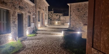 a stone building with a stone walkway and steps leading up to a building