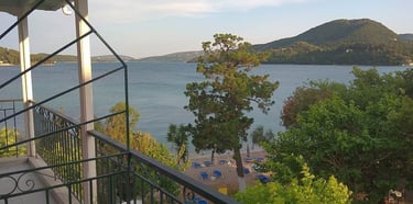 a balcony with a view of the sea and mountains