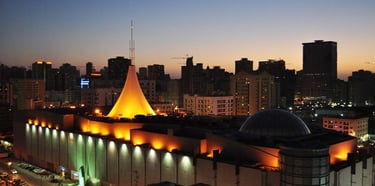 a city skyline at night time with a church and a church steeple