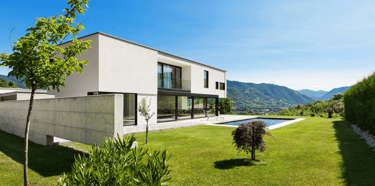 a house with a pool and a pool in the background