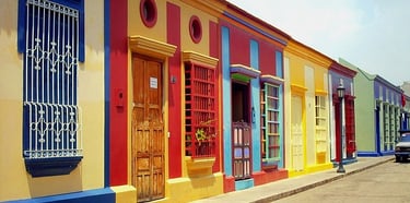 a row of colorful buildings with a car parked in front of them