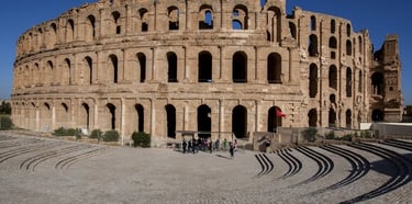 Roman ruins at Dougga, Sahara desert camel ride, and traditional desert campfire experience in Tunis