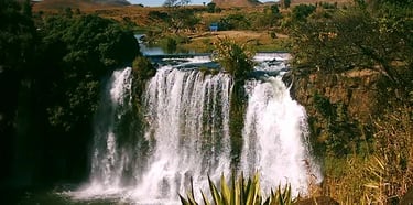 Lake Itasy with greenery, volcanic crater, and horseback rider in Madagascar.