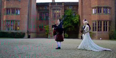 newly weds walking behind bagpiper 
