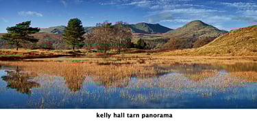 a lake with a mountain in the background kelly hall tarn lake district