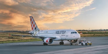 Volotea airplane on airport tarmac during sunset