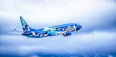 Alaska Airlines plane flies in the sky