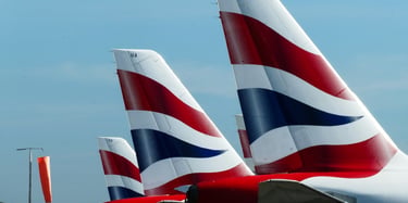 British Airways planes' tails visible in airport