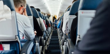Interior of airplane with sitting people
