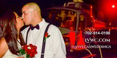 wedding couple kissing by a helicopter