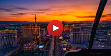 Aerial sunset view of the Las Vegas Strip featuring the Eiffel Tower at Paris Las Vegas and city lights.