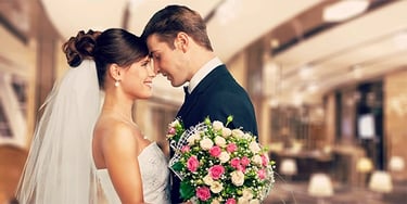 a bride and groom standing in a hotel lobby