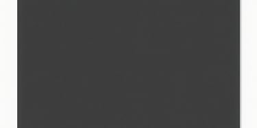 A laptop screen showing code and design elements in progress with a coffee cup nearby.