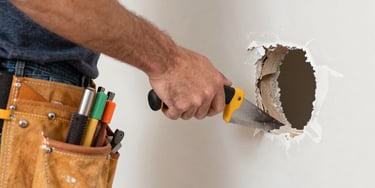 A friendly handyman fixing a kitchen cabinet in a bright, cozy home.