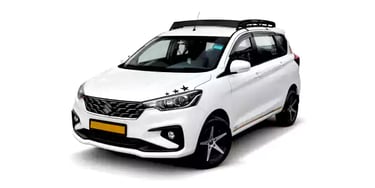 White Maruti Ertiga one way taxi by Saini taxi services with a luggage carrier rack