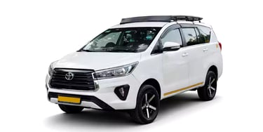 White Toyota Innova Crysta one way taxi by Saini taxi services with a luggage carrier rack