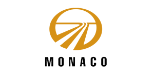 Gold Monaco RV logo featuring a road graphic inside a circle on a black background.