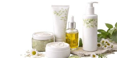 Natural skincare products including organic face cream, herbal serum, and lotion with chamomile flowers.