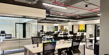 a large open office with a couch and chairs - flexible workspace