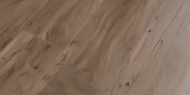 A craftsman installing floating parquet flooring in a bright living room.