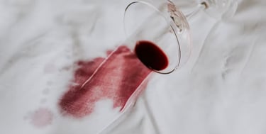 A red wine stain on a white fabric