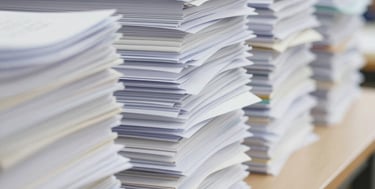 Close-up of hands stamping and legalizing official papers with a seal.