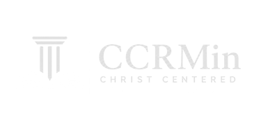 White logo for Christ Centered Reformed Ministries featuring an open Bible and a classic pillar column.