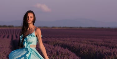 a woman in a blue dress standing in a lavender field