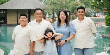 extended family posing together near the pool at Movenpick Jimbaran Bali during a relaxed session