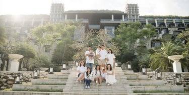 Large family walking down the iconic staircase at The Apurva Kempinski Nusa Dua during a Bali family photography session