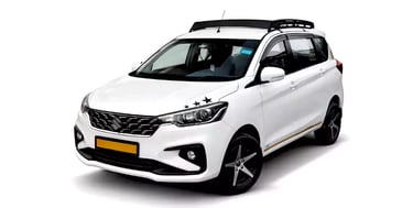 White Maruti Ertiga one way taxi by Saini taxi services with a luggage carrier rack