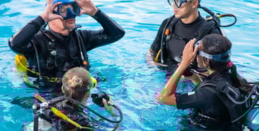 a group of scuba divers in a pool