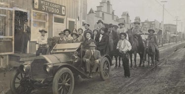 A group portrait of players, crew, and executives in front of Pathé Studios on Allesandro Street 