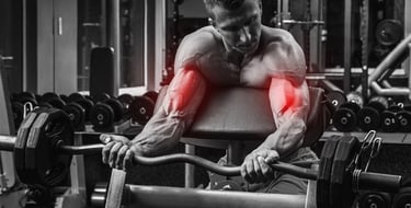 Bodybuilder performing preacher curls with an EZ curl bar to target biceps in a gym.