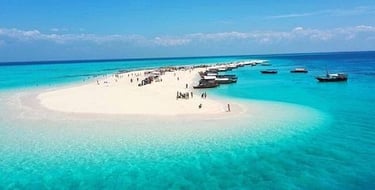 A stunning aerial view of Nakupenda Sandbank in Zanzibar, Tanzania, showcasing pristine white sand, turquoise waters