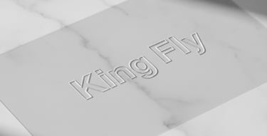 A high-end custom cosmetic pouch placed on a desk next to a business report.